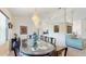 Formal dining area with chandelier and unique table adjacent to living room and kitchen at 4716 Nw 34Th Pl, Ocala, FL 34482