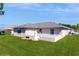 Well-maintained single-story home with a gray roof and lush green lawn at 4716 Nw 34Th Pl, Ocala, FL 34482