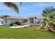 Lovely single-story home with manicured lawn, mature palm trees, and walkway to gated front entry at 4716 Nw 34Th Pl, Ocala, FL 34482