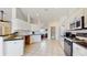 Bright kitchen with white cabinetry, contrasting countertops, stainless appliances, and tile flooring at 4716 Nw 34Th Pl, Ocala, FL 34482