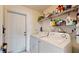 Functional laundry room equipped with a washer, dryer, and shelving at 4716 Nw 34Th Pl, Ocala, FL 34482