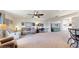 Bright and airy living room with neutral carpeting, ceiling fan, and comfortable seating at 4716 Nw 34Th Pl, Ocala, FL 34482