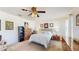 Spacious main bedroom with ceiling fan, carpet flooring, and natural lighting at 4716 Nw 34Th Pl, Ocala, FL 34482