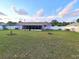 Expansive backyard featuring a large green lawn, fenced perimeter, and a screened-in porch at 5606 Sw 107Th St, Ocala, FL 34476