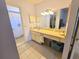 Practical bathroom layout with a single sink vanity, large mirror, and a shower with a curtain at 5606 Sw 107Th St, Ocala, FL 34476