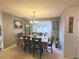 Inviting dining room with tile floors, a chandelier, and large windows providing natural light at 5606 Sw 107Th St, Ocala, FL 34476
