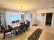 Cozy dining area with tile flooring, a chandelier, and views into the bedroom and front entry at 5606 Sw 107Th St, Ocala, FL 34476