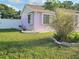A well-kept lawn complements the home's corner, enhanced by a clean fence and decorative plants at 5606 Sw 107Th St, Ocala, FL 34476