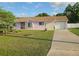 Attractive single-story home featuring a driveway and a well-maintained front yard with landscaping at 5606 Sw 107Th St, Ocala, FL 34476