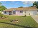 Charming single-story home with a well-maintained lawn and inviting curb appeal under a blue sky at 5606 Sw 107Th St, Ocala, FL 34476