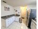 Efficient kitchen space with granite countertops, ample cabinet storage, and tile flooring at 5606 Sw 107Th St, Ocala, FL 34476
