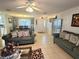 Spacious living room featuring tile flooring and neutral decor, with a dining area view at 5606 Sw 107Th St, Ocala, FL 34476