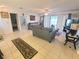 Open-concept living room with tile flooring and sliding doors to the patio, offering abundant natural light at 5606 Sw 107Th St, Ocala, FL 34476