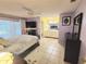 Bright primary bedroom with tile flooring, and ensuite bath, under a ceiling fan at 5606 Sw 107Th St, Ocala, FL 34476