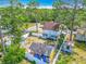 Aerial view of the property showcasing the house, detached building, and lush surroundings within a fenced yard at 6403 Summit Dr, Orlando, FL 32810