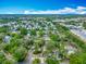 Aerial view of the neighborhood with houses, lush trees, and clear blue skies at 6403 Summit Dr, Orlando, FL 32810