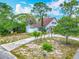 Aerial view of the home within a residential area, surrounded by trees at 6403 Summit Dr, Orlando, FL 32810