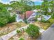 Aerial view showcasing a quaint two-story home amidst a vibrant neighborhood with lush trees and greenery at 6403 Summit Dr, Orlando, FL 32810