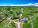 Aerial shot of house with mature landscaping, a driveway, and nearby street at 6403 Summit Dr, Orlando, FL 32810