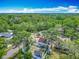 Aerial view highlighting the property's location within a lush, tree-filled neighborhood, showing nearby streets and landscaping at 6403 Summit Dr, Orlando, FL 32810