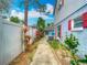 A home's backyard featuring a walkway, garden area, and privacy fence at 6403 Summit Dr, Orlando, FL 32810