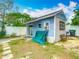 Cozy backyard featuring a detached blue building, stone pathway, and well-maintained fence, ideal for relaxation and privacy at 6403 Summit Dr, Orlando, FL 32810