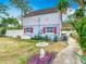 Backyard of a charming home featuring landscaping and a bird bath at 6403 Summit Dr, Orlando, FL 32810