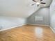 Spacious bedroom with wood floors, vaulted ceiling, and a window at 6403 Summit Dr, Orlando, FL 32810