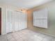Bedroom featuring neutral walls, tile floors, a window and two closets at 6403 Summit Dr, Orlando, FL 32810