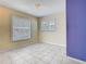 Bedroom featuring neutral walls, tile floors, with two windows offering natural light at 6403 Summit Dr, Orlando, FL 32810