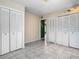 Bedroom featuring neutral walls, tile floors, with three closets offering ample storage at 6403 Summit Dr, Orlando, FL 32810