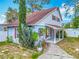 Charming blue two-story home with a sidewalk leading to the front door and unique desert landscaping at 6403 Summit Dr, Orlando, FL 32810