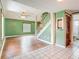 Inviting living room with hardwood flooring, staircase, and adjacent bathroom at 6403 Summit Dr, Orlando, FL 32810