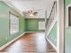 Bright living room featuring hardwood floors, a ceiling fan, and natural light from the window at 6403 Summit Dr, Orlando, FL 32810