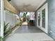 Covered patio with ceiling fan, a pathway to the back, and privacy fence at 6403 Summit Dr, Orlando, FL 32810