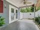View of the covered patio with ceiling fan and access to the fenced backyard at 6403 Summit Dr, Orlando, FL 32810
