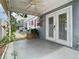 A view of the covered patio of this home, including ceiling fan and double doors at 6403 Summit Dr, Orlando, FL 32810