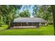Spacious screened-in patio and backyard with lush lawn, providing an ideal setting for relaxation and entertainment at 733 Se 67Th Ln, Ocala, FL 34480