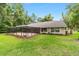 Spacious screened-in patio and backyard with lush lawn, offering a perfect outdoor living space at 733 Se 67Th Ln, Ocala, FL 34480