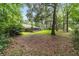 Spacious backyard with a screened-in patio, surrounded by mature trees offering natural beauty and privacy at 733 Se 67Th Ln, Ocala, FL 34480