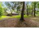 Spacious backyard with mature trees, green grass and a screened patio area, perfect for outdoor gatherings at 733 Se 67Th Ln, Ocala, FL 34480