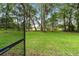 Large, well-maintained backyard, partially fenced in with mature trees providing ample shade and privacy at 733 Se 67Th Ln, Ocala, FL 34480