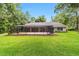 The spacious backyard is highlighted by a large screened-in patio that provides an amazing area for relaxing and entertaining at 733 Se 67Th Ln, Ocala, FL 34480