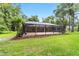 A large screened-in patio provides the perfect extension to the home and overlooks the expansive backyard at 733 Se 67Th Ln, Ocala, FL 34480
