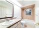 Bathroom featuring neutral tiling, a single vanity, a shower-tub, and a window at 733 Se 67Th Ln, Ocala, FL 34480
