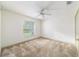 Bedroom featuring a large window, a ceiling fan, and neutral carpeting, creating a serene and inviting atmosphere at 733 Se 67Th Ln, Ocala, FL 34480