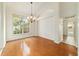 Charming dining area with hardwood floors, chandelier, and natural light at 733 Se 67Th Ln, Ocala, FL 34480