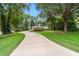 Long driveway leading to a charming home nestled amidst mature trees and lush landscaping, offering privacy and curb appeal at 733 Se 67Th Ln, Ocala, FL 34480