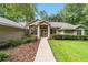 Inviting single-story home featuring a well-maintained lawn, elegant columns, and lush landscaping at 733 Se 67Th Ln, Ocala, FL 34480