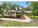 Charming single-story home with manicured lawn and inviting walkway, surrounded by mature trees and lush landscaping at 733 Se 67Th Ln, Ocala, FL 34480